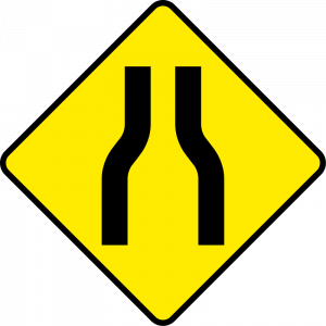 Road narrows on both sides
